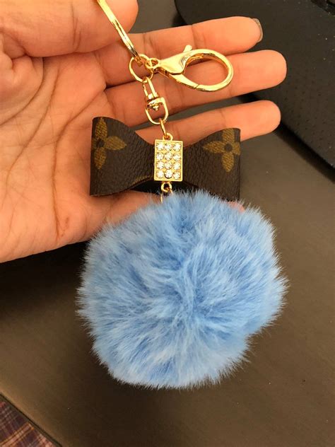 louis vuitton pom pom keychain|Louis Vuitton luggage charm.